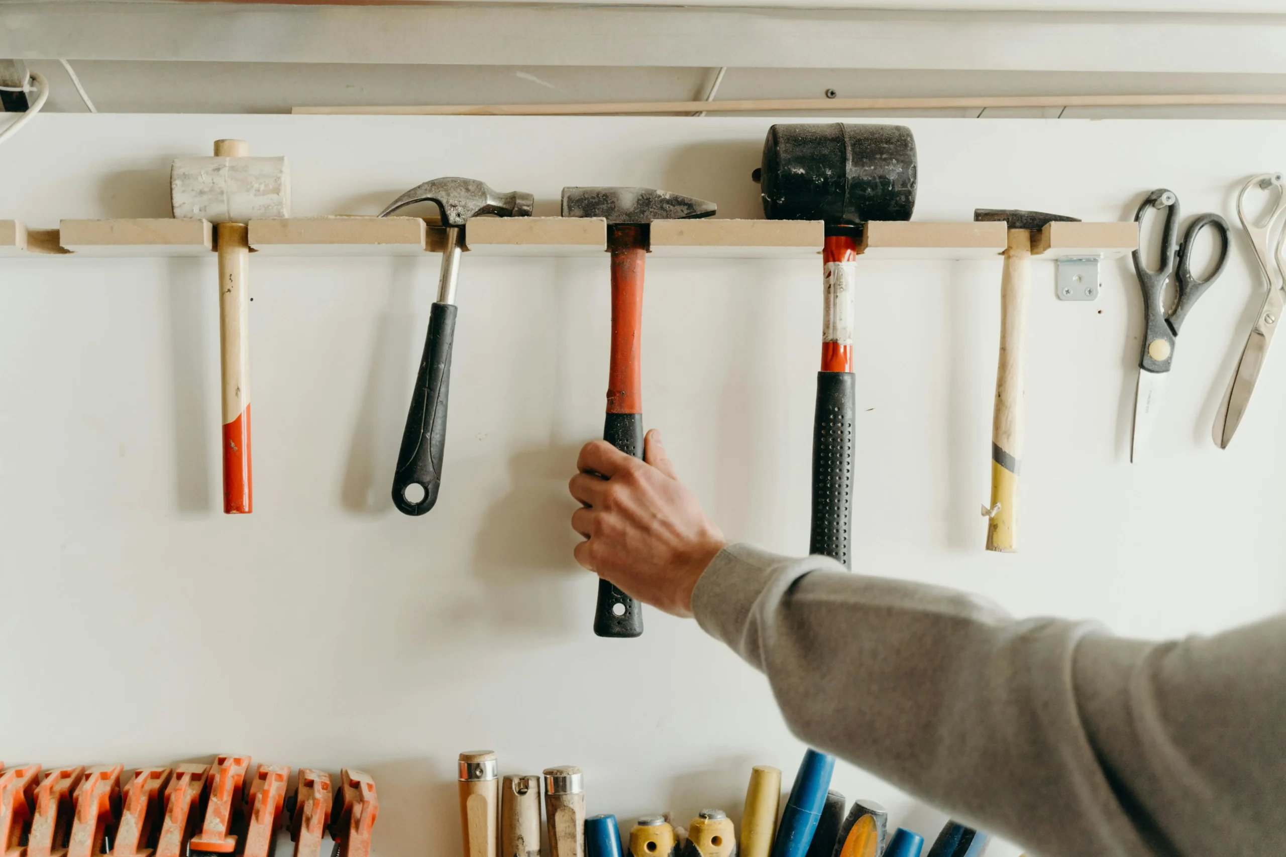 Handyman tools neatly organized on a wall, representing professional home repair and remodeling services.