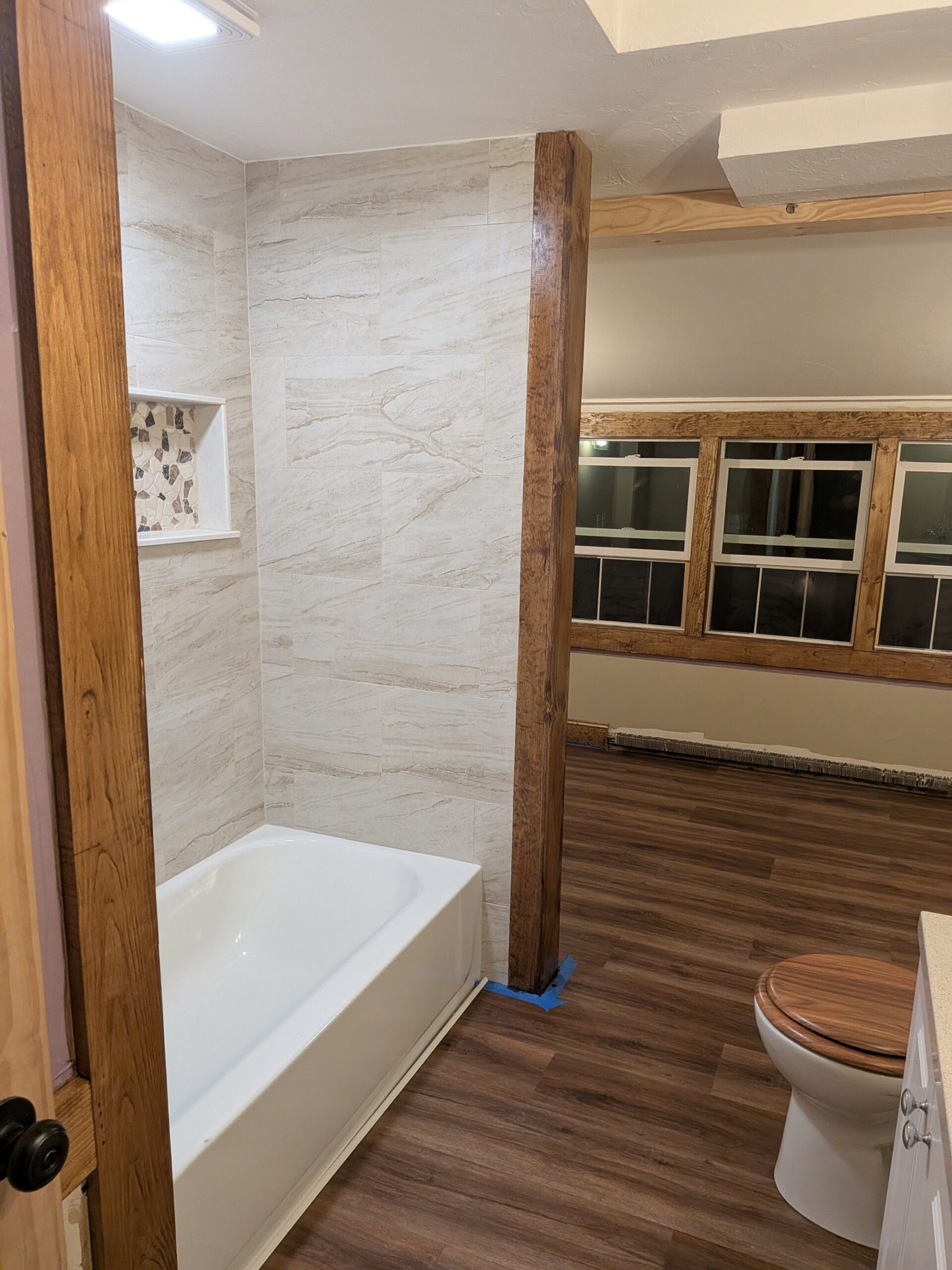 Custom stained wood beams, craftsman window trim and finished details — bathroom renovation Hubbardston Massachusetts