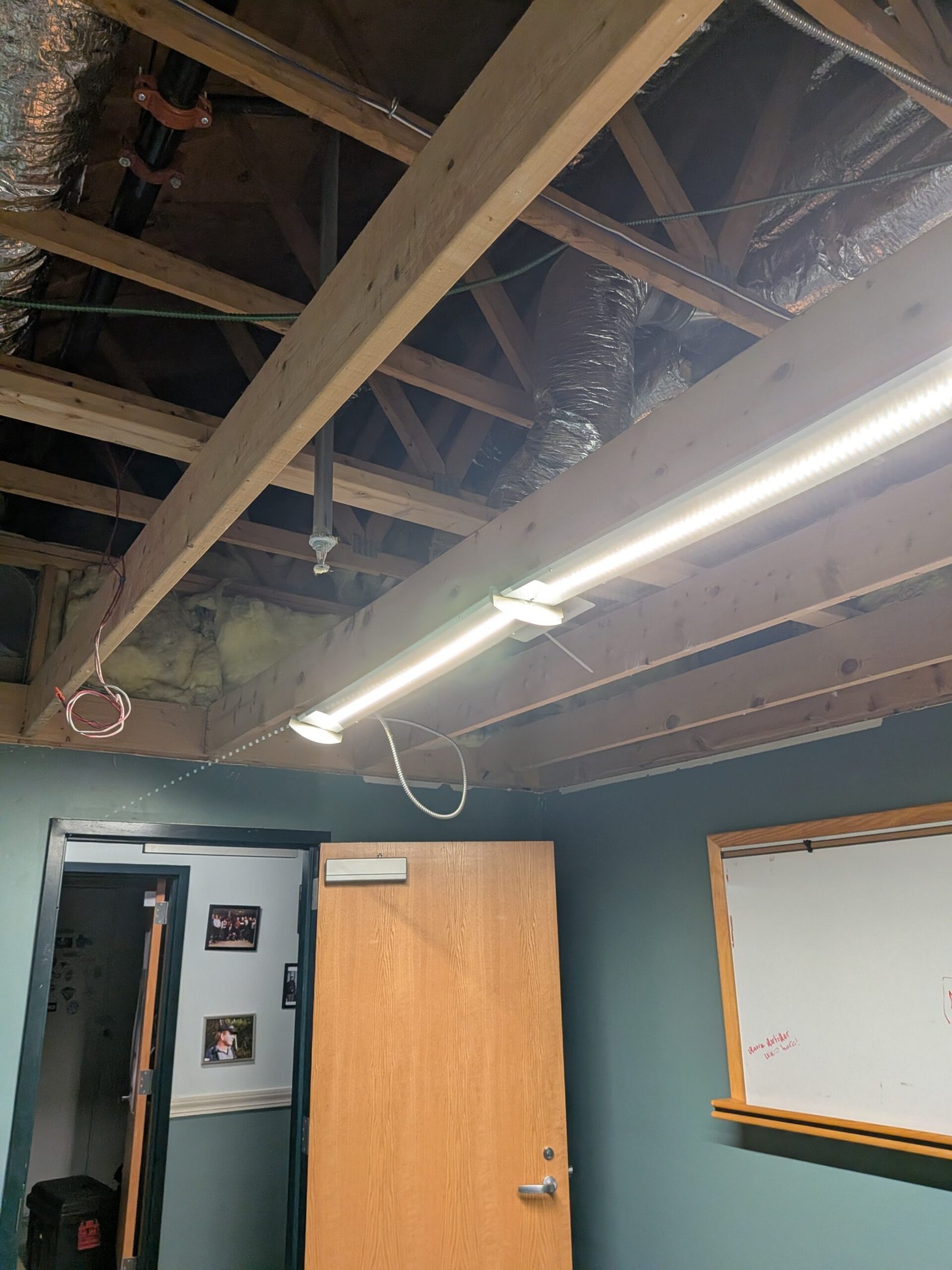 Exposed ceiling joists, ductwork and sprinkler line after water damage, Central Massachusetts office